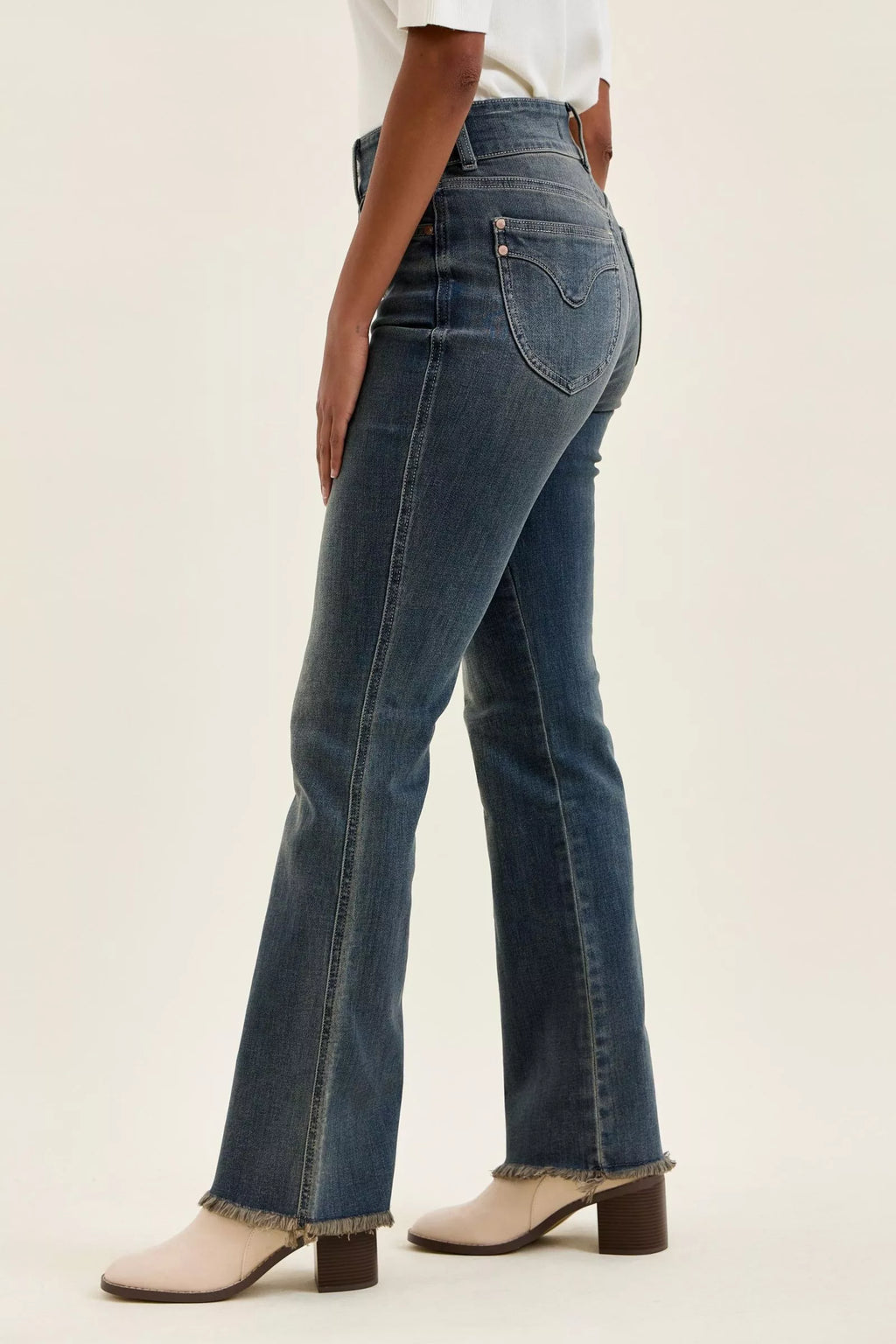 Medium-wash high-waist bootcut jeans with frayed cuffs and double-button waist