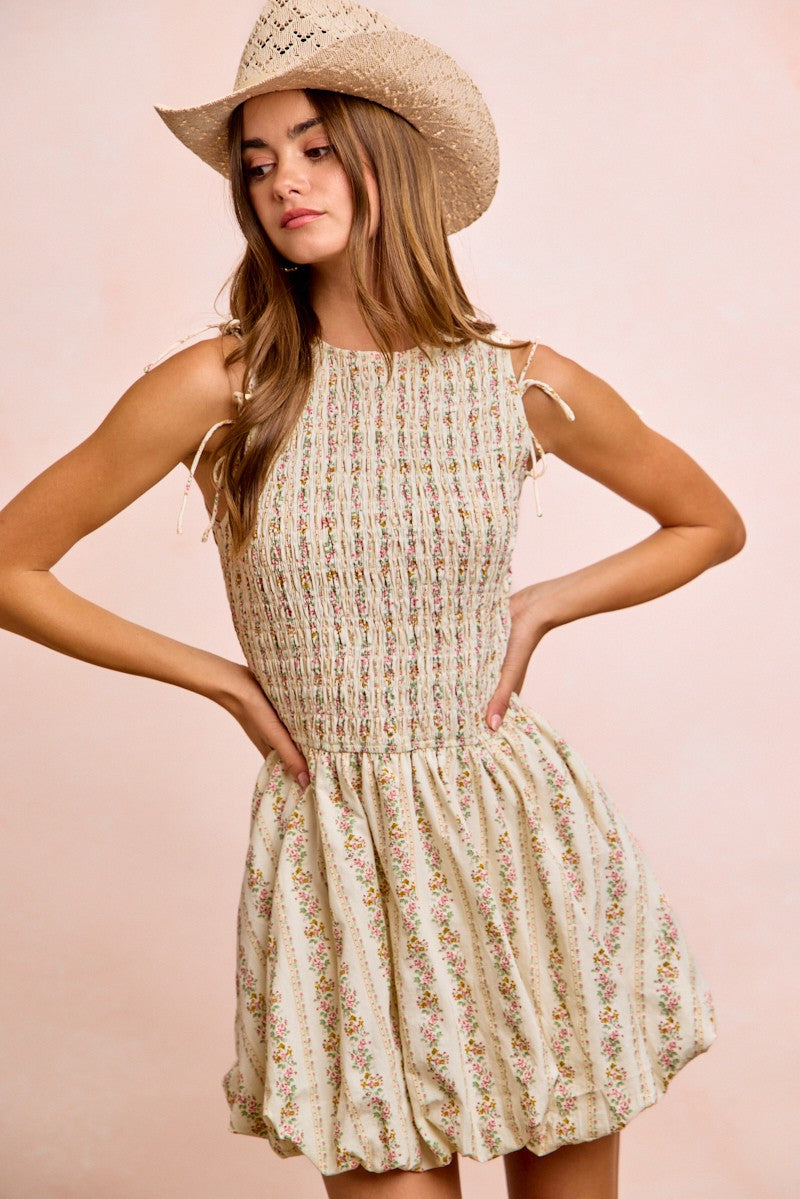 Ivory floral dress with smocked bodice and gathered skirt, tie-front puff sleeves