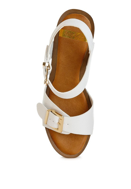 White leather clog sandals, side view, showing open toe and gold buckle strap