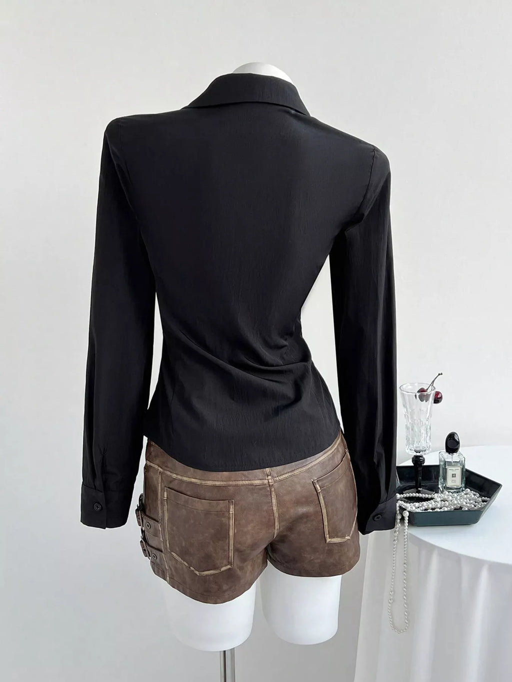Black slim-fit shirt back view, long sleeves and fitted waist