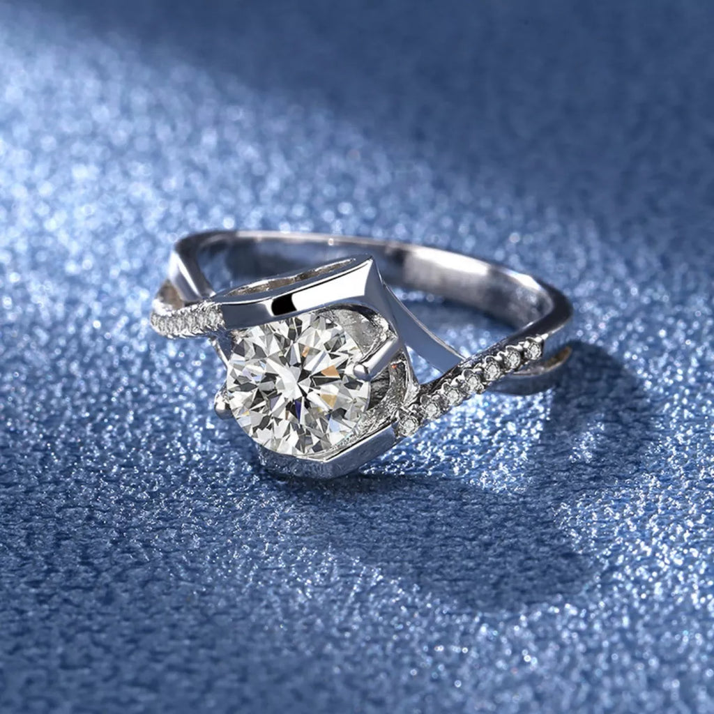 Silver moissanite ring with geometric setting and pavé accents on the band