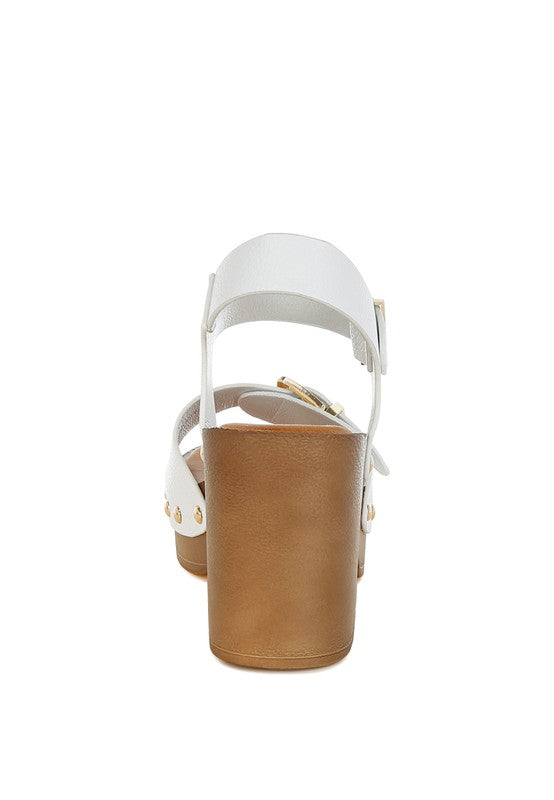 White leather heeled sandals with ankle strap and gold buckle; back view