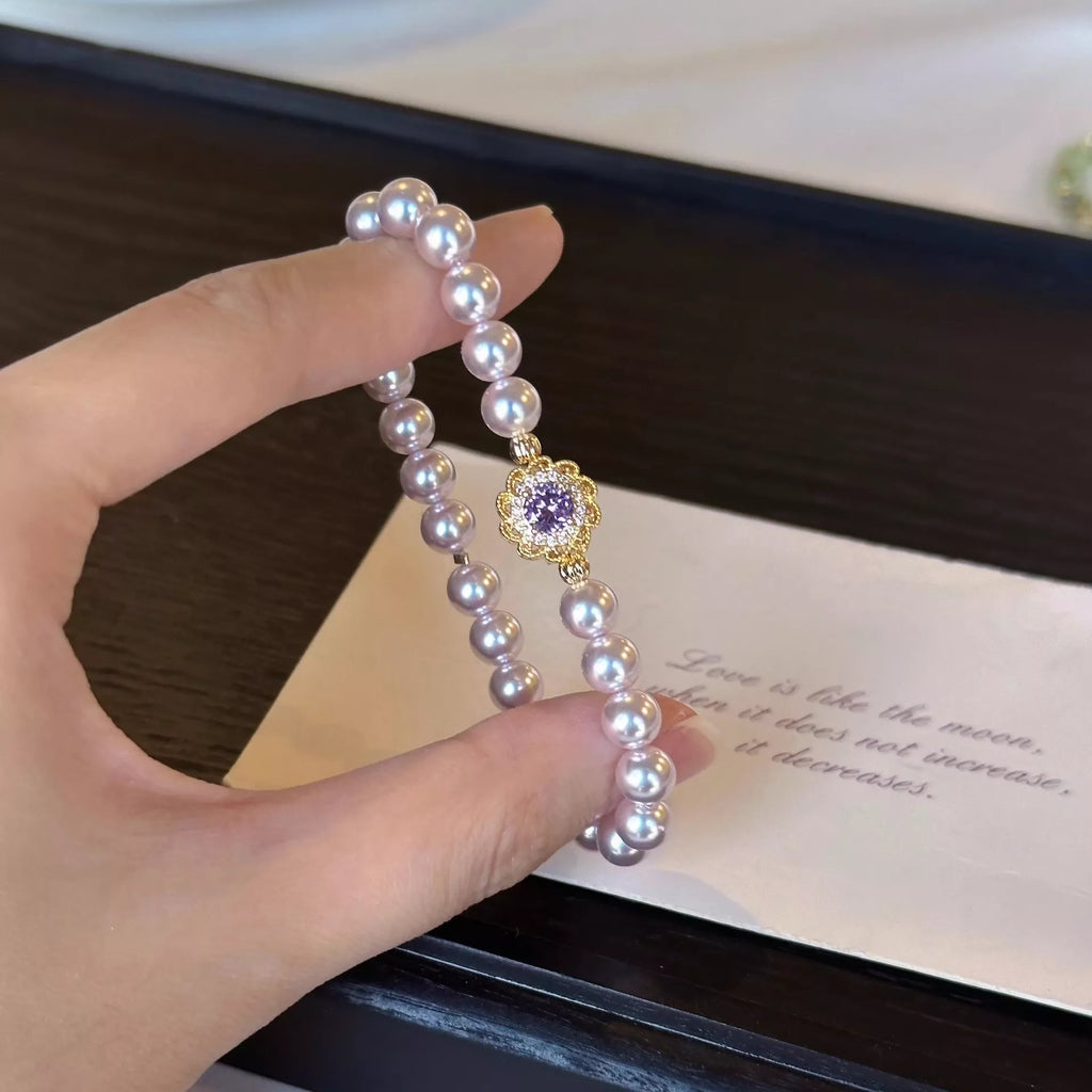 18K Gold-Plated Pearl Bracelet with pearl bead strands and gold floral charm at center