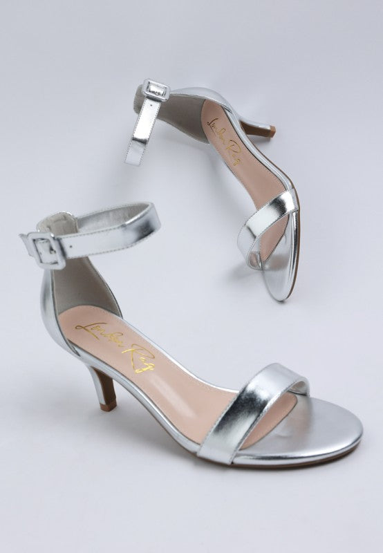 Metallic silver kitten heel sandals with ankle strap and open round toe