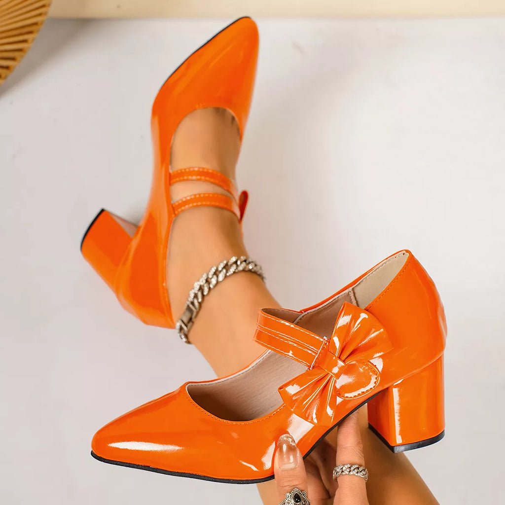 Orange point toe block heels with bow, ankle straps, and chunky mid-height heel