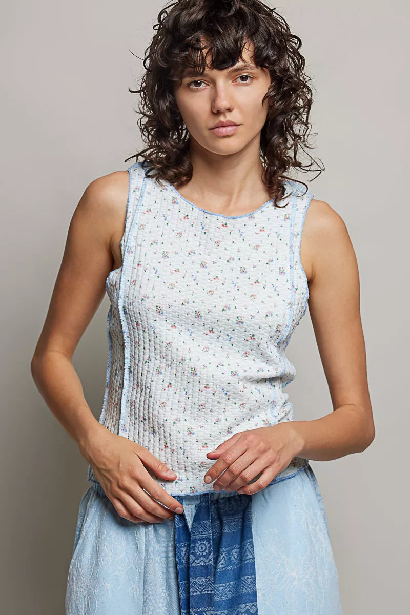 Ribbed knit tank top with round neck; light blue micro-floral print and side seams