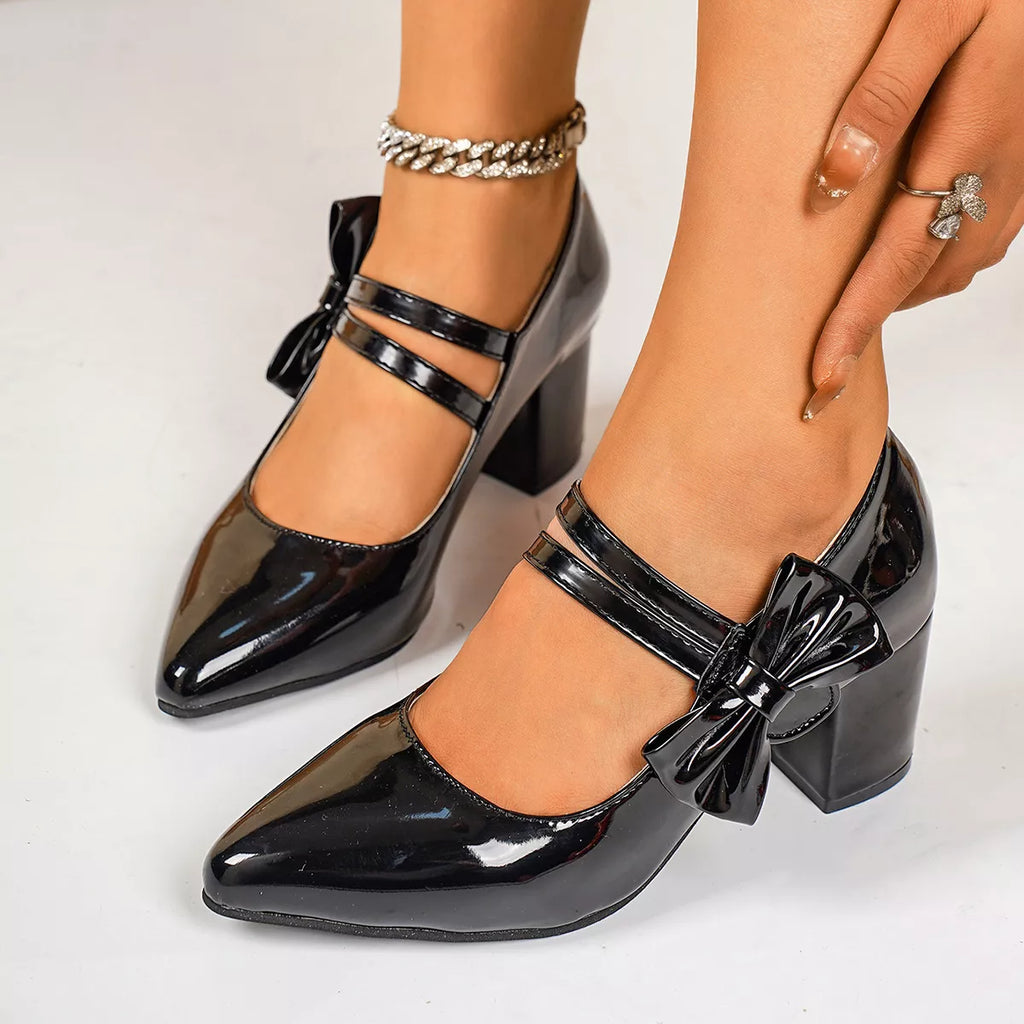 Point toe block heels in black patent with bow detail and ankle strap