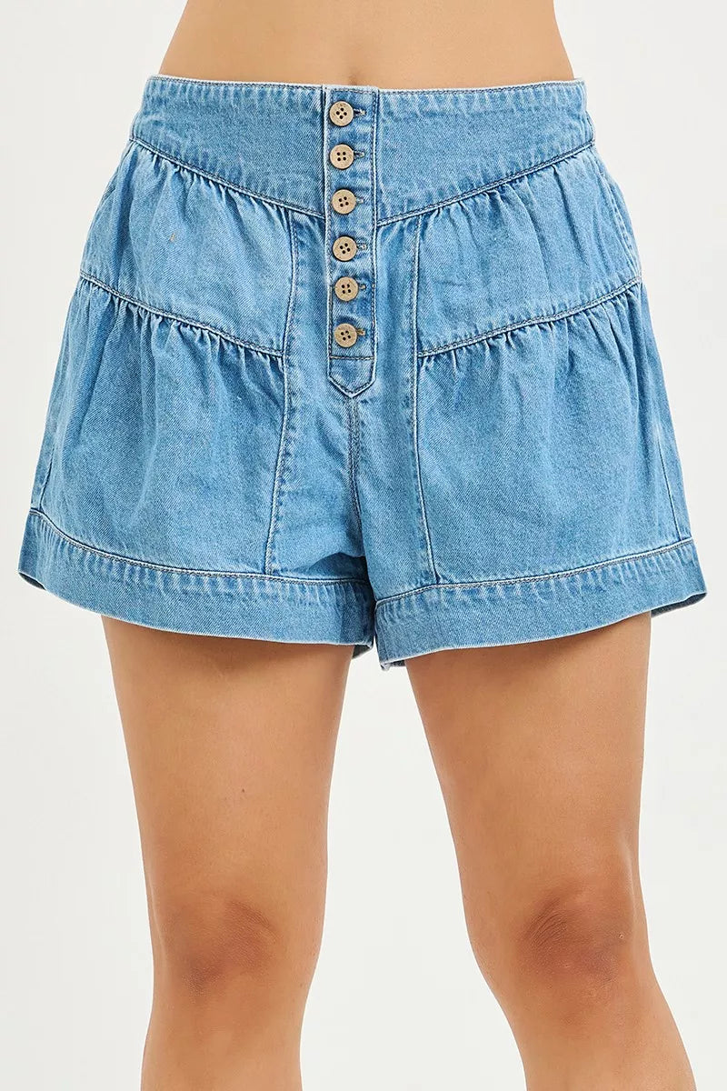 Light blue denim slouchy shorts with elastic waistband, shirred tiers, front button placket