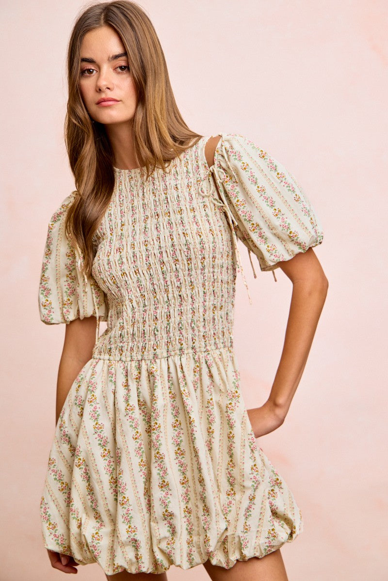 Ivory floral short dress with smocked chest, puff sleeves with tie cuffs, tiered skirt
