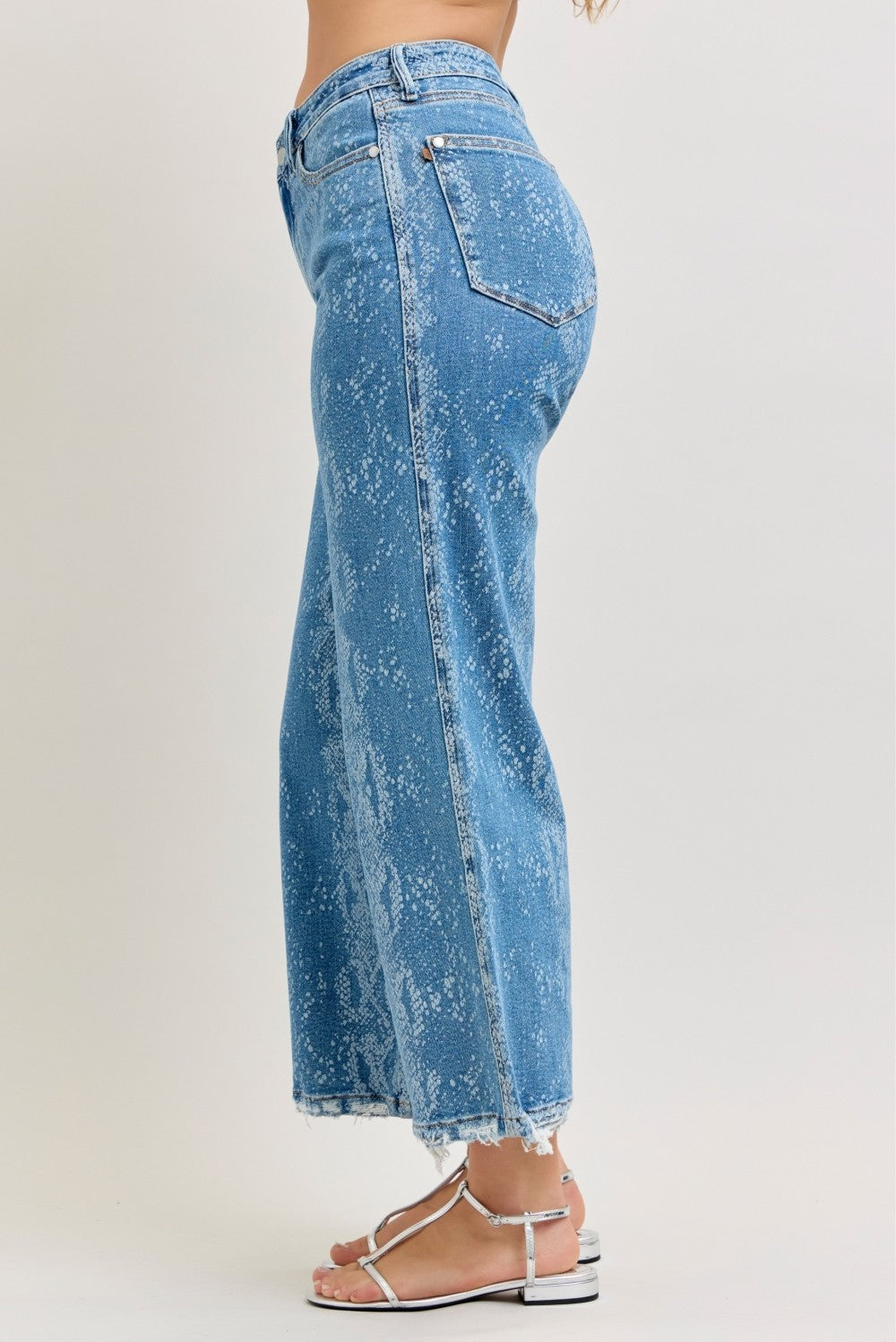 Back view: high-rise ankle wide-leg jeans, blue snake-print with two back pockets.