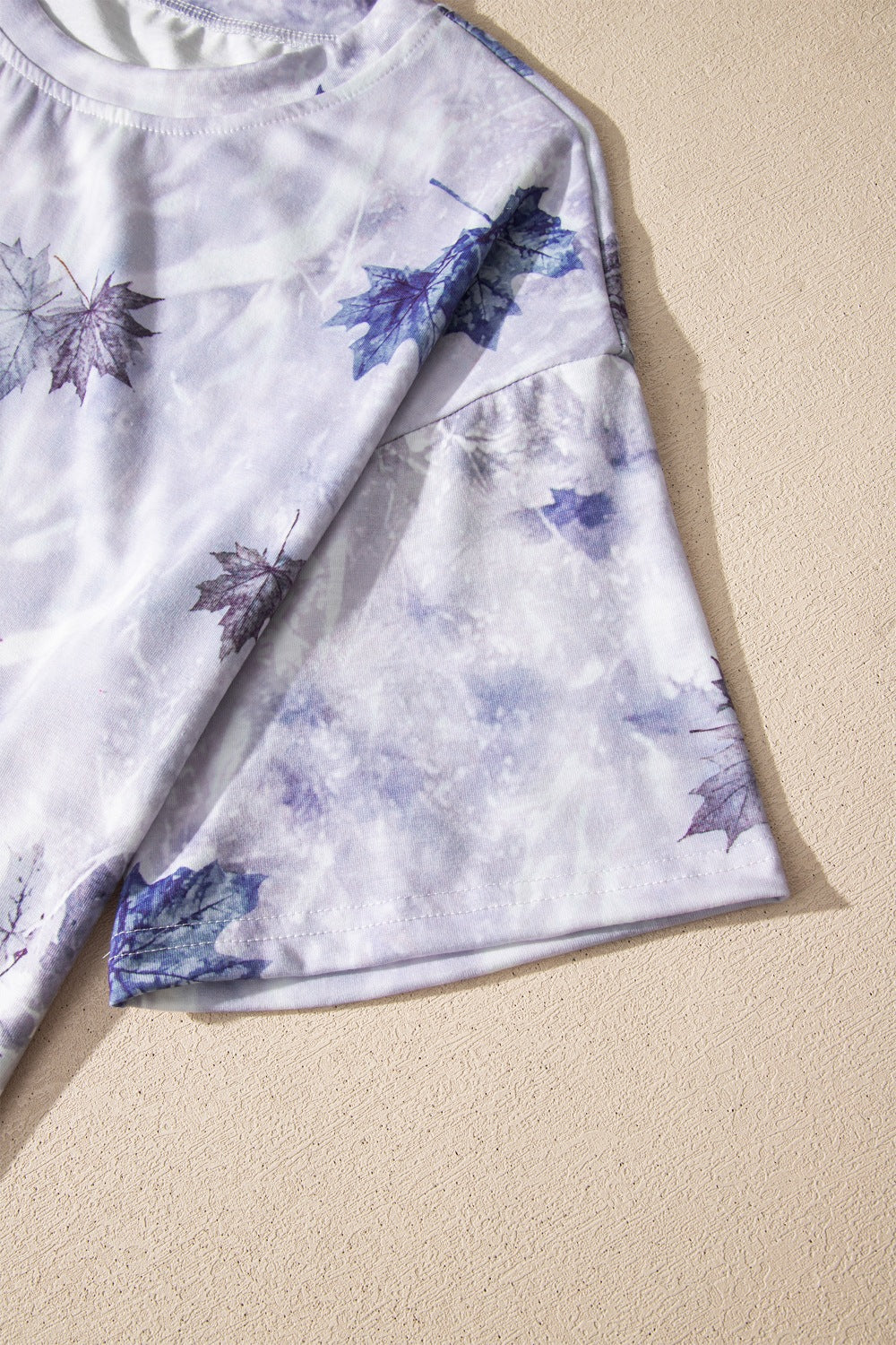Light gray short-sleeve tunic tee with woodland camouflage leaf print, side seam detail