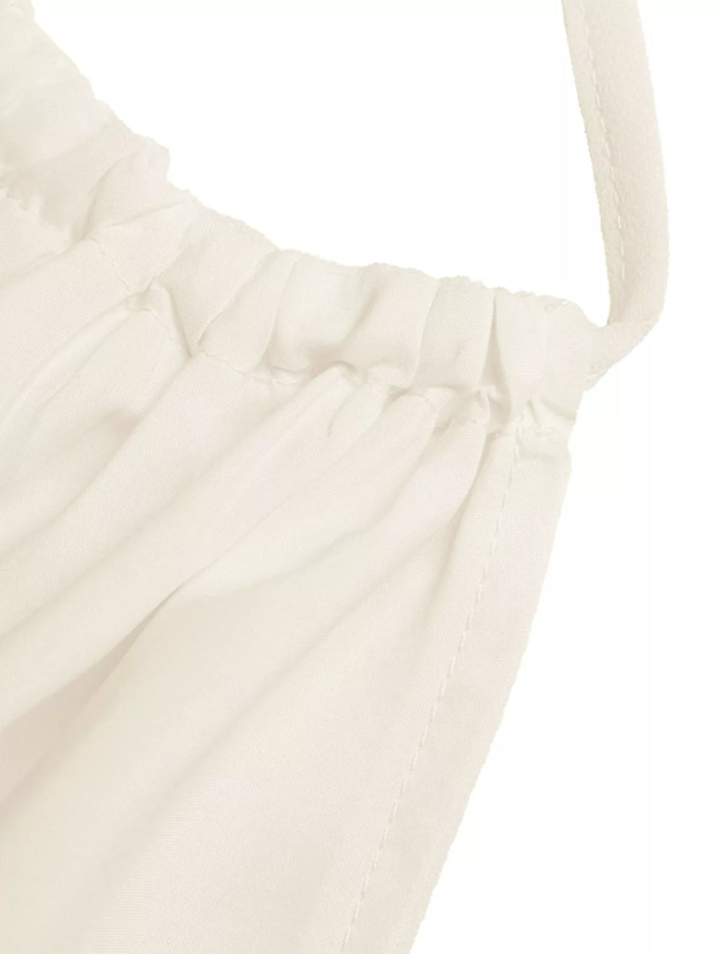 White tiered cami fabric close-up with pleated texture and gathered seam