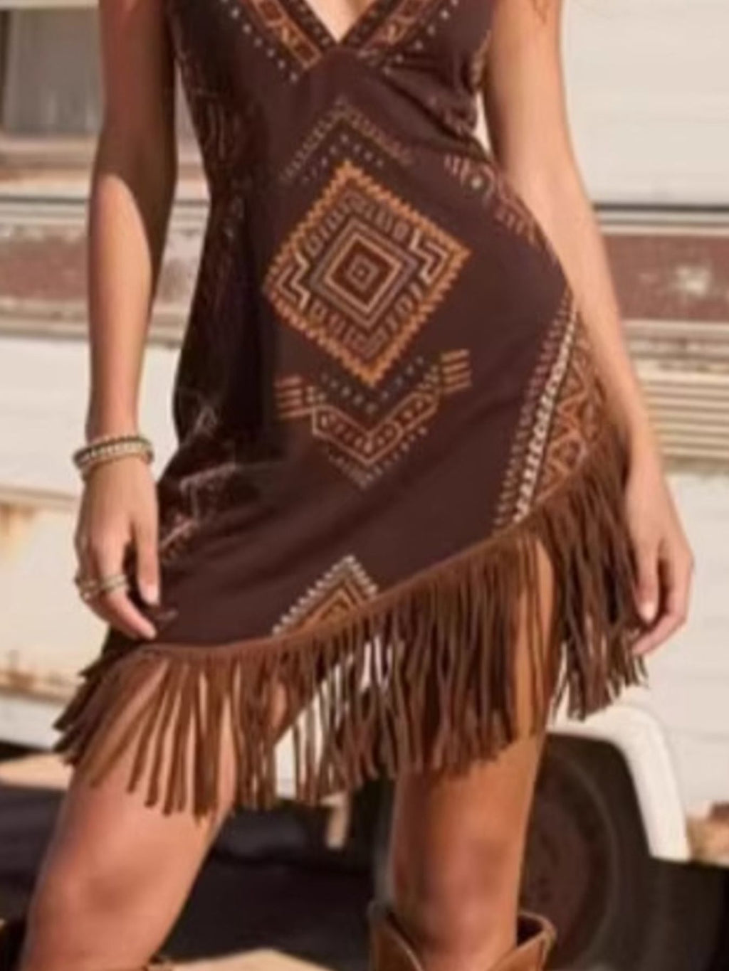 Brown mini dress with patterned geometric panel and long fringe hem
