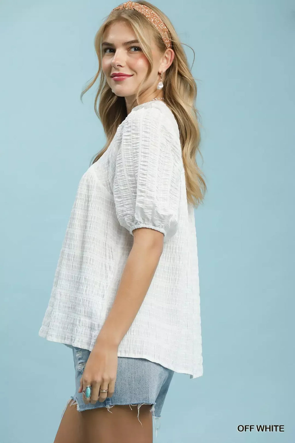 Off-White textured blouse with puff sleeves, side view