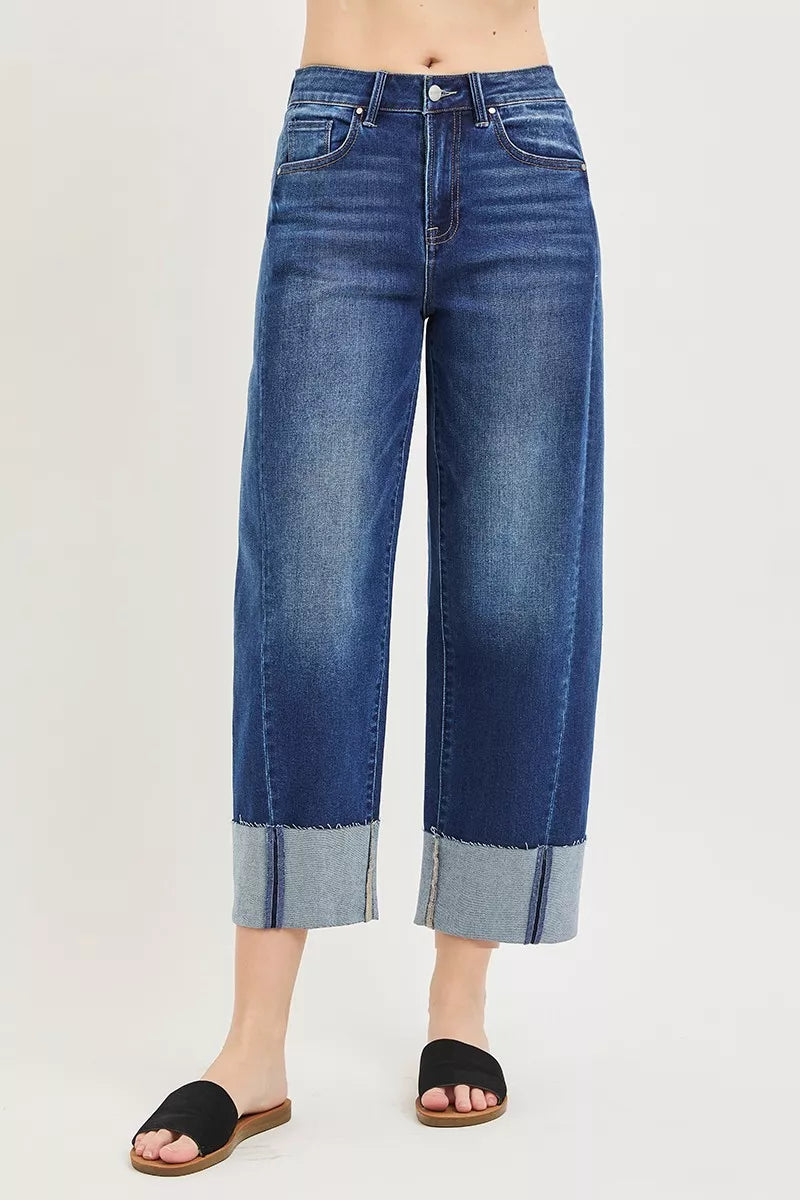 Dark blue barrel cuff crop jeans front with belt loops, button fly, and contrast cuff