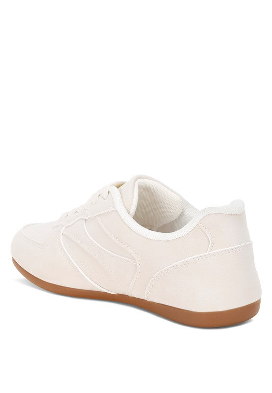 Back view of ivory lace-up sneakers with cushioned collar and gum outsole