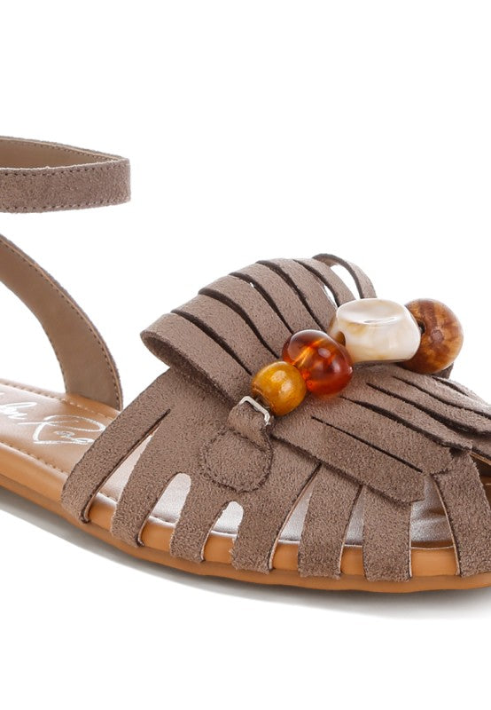 Taupe open-toe flat sandal with fringe overlays and multi-color bead embellishments