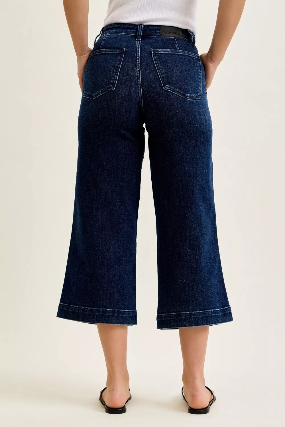 High-waist wide-leg ankle jeans in dark blue, back view with back pockets