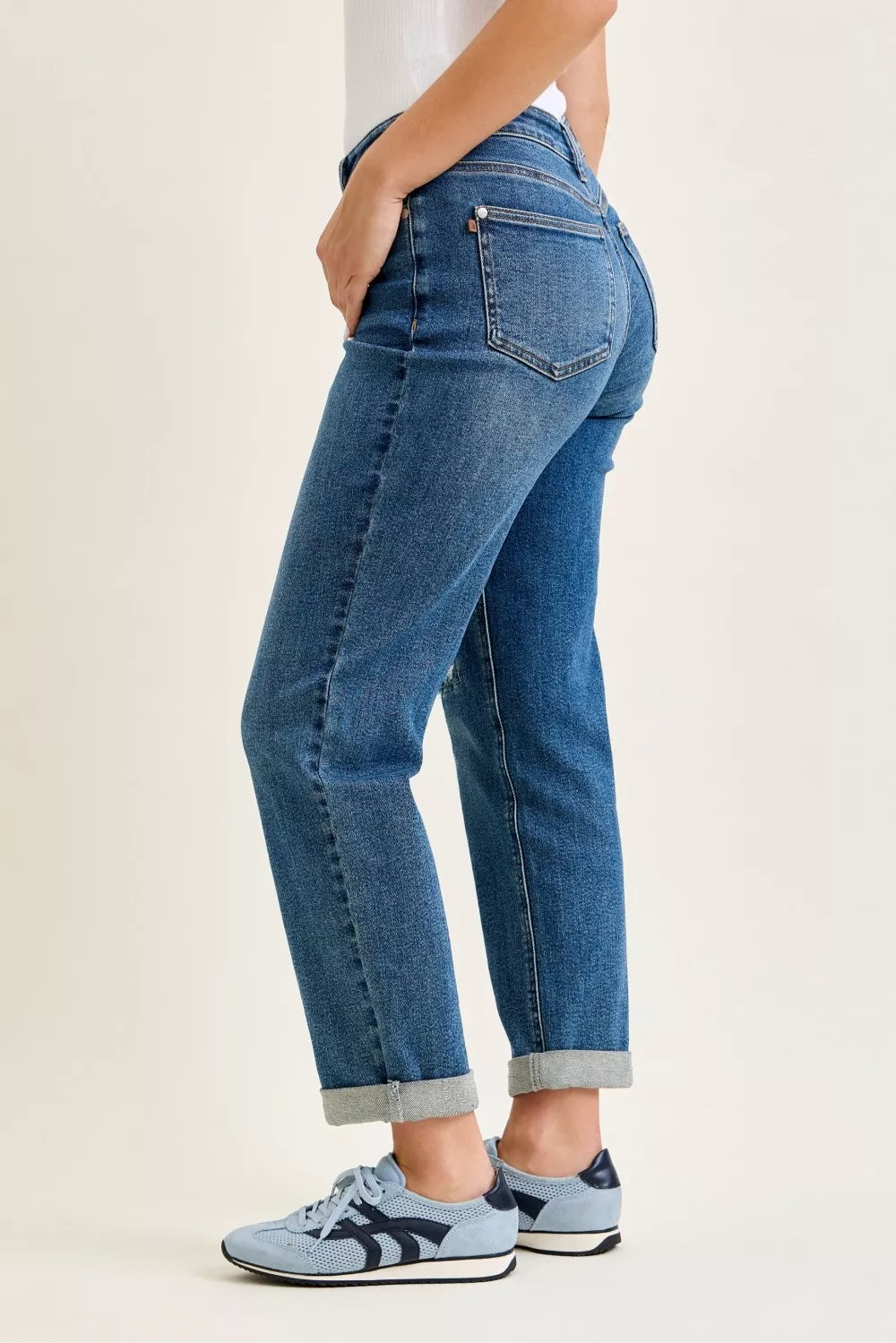 Medium blue mid-rise boyfriend jeans, back view with pocket stitching and cuff hem
