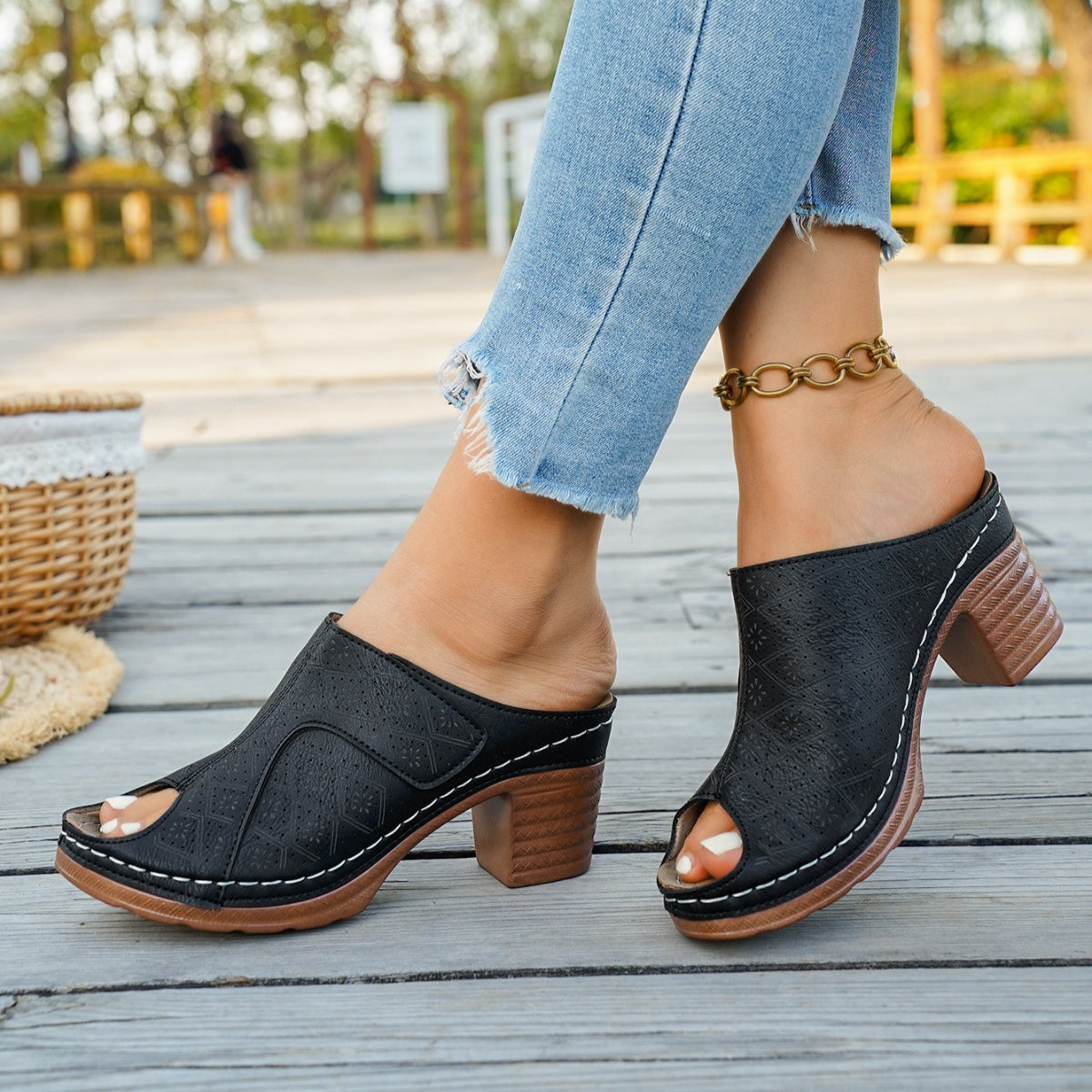 Black peep toe block heel mule sandals with patterned upper and chunky heel