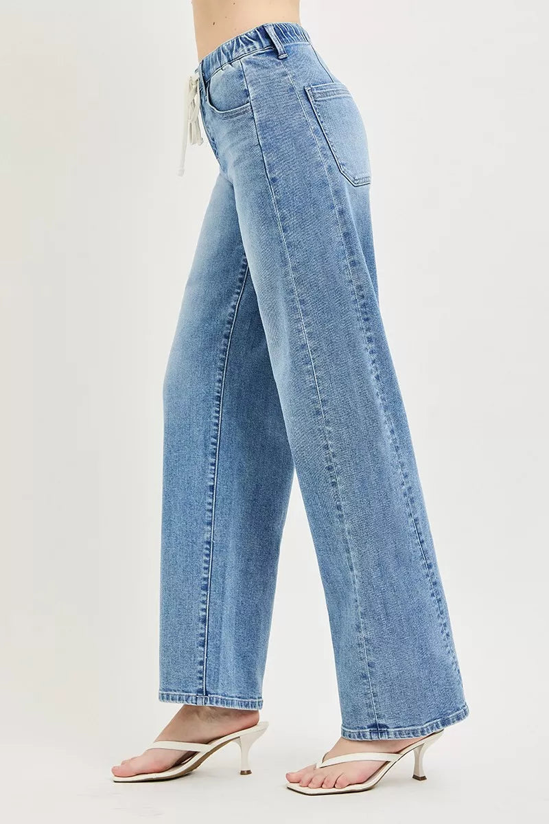Light wash relaxed-fit jeans with drawstring waist and wide leg, side view