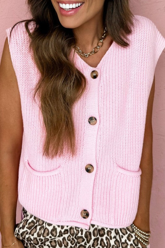 Pink knit sweater vest with button front and patch pockets, V-neck sleeveless