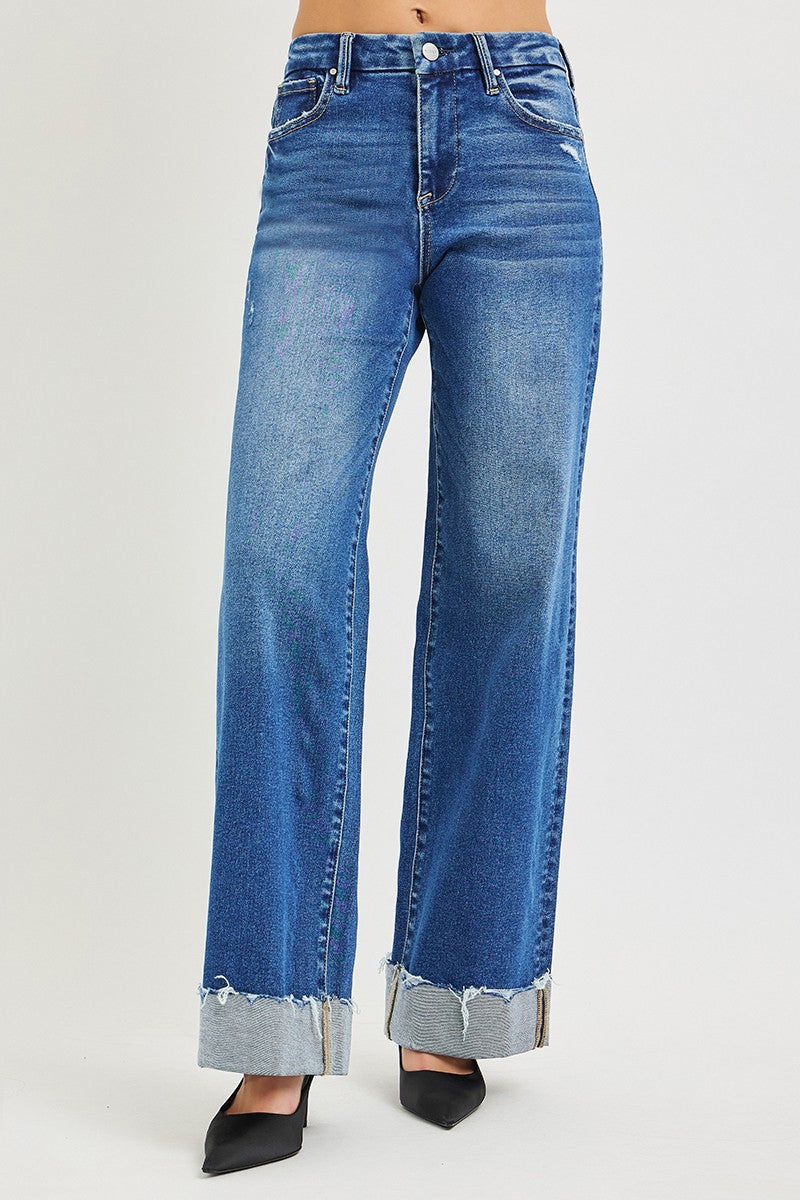 Medium wash blue wide-leg jeans with high rise and cuffed, frayed hem