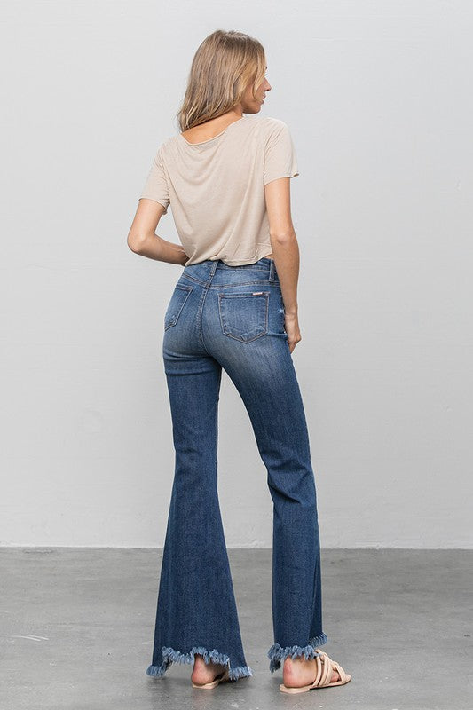 Wide flare dark denim jeans, rear view, frayed hem and button detailing
