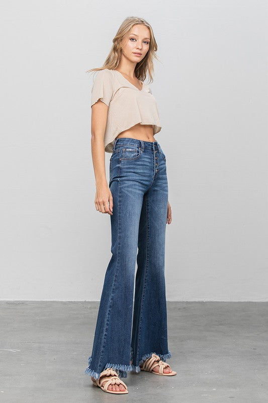 Dark blue wide flare jeans with button fly style and frayed hem