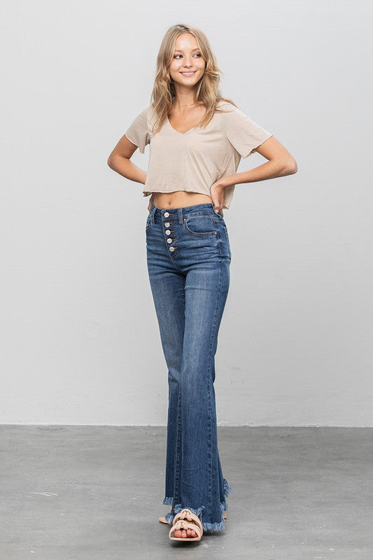 Wide flare jeans in dark denim with button detail and raw frayed hem