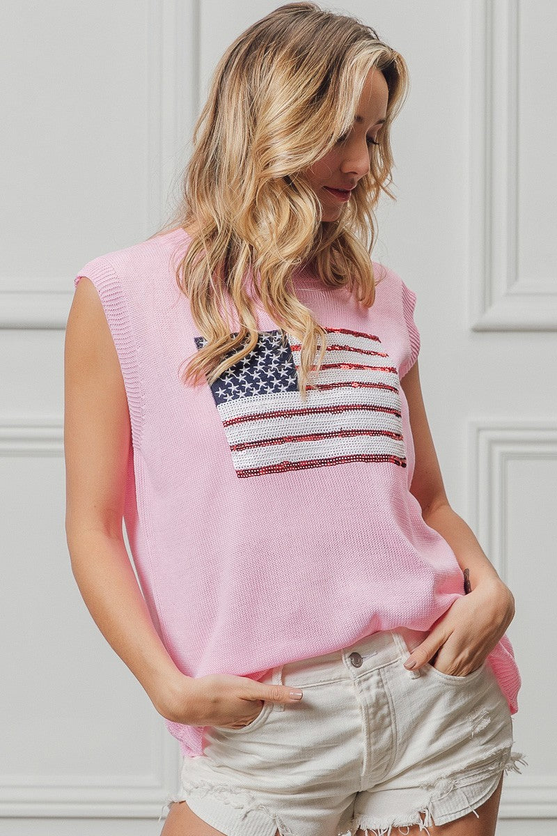 Pink sleeveless knit top with American flag sequin patch, curved ribbed hem