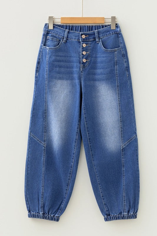 Blue denim jeans on hanger, buttoned fly, front seams, cuffed hem