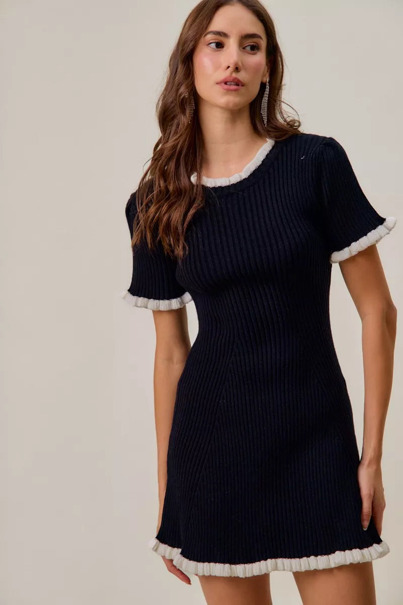 Black contrast knit mini dress with white ruffle collar and hem, short sleeves