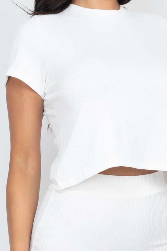Close-up of white ribbed knit: cropped top and matching midi skirt waistband