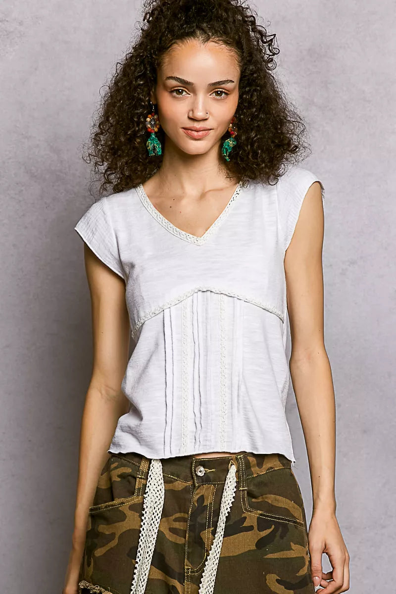 Off-white V-neck textured knit top with lace trim detail, front view