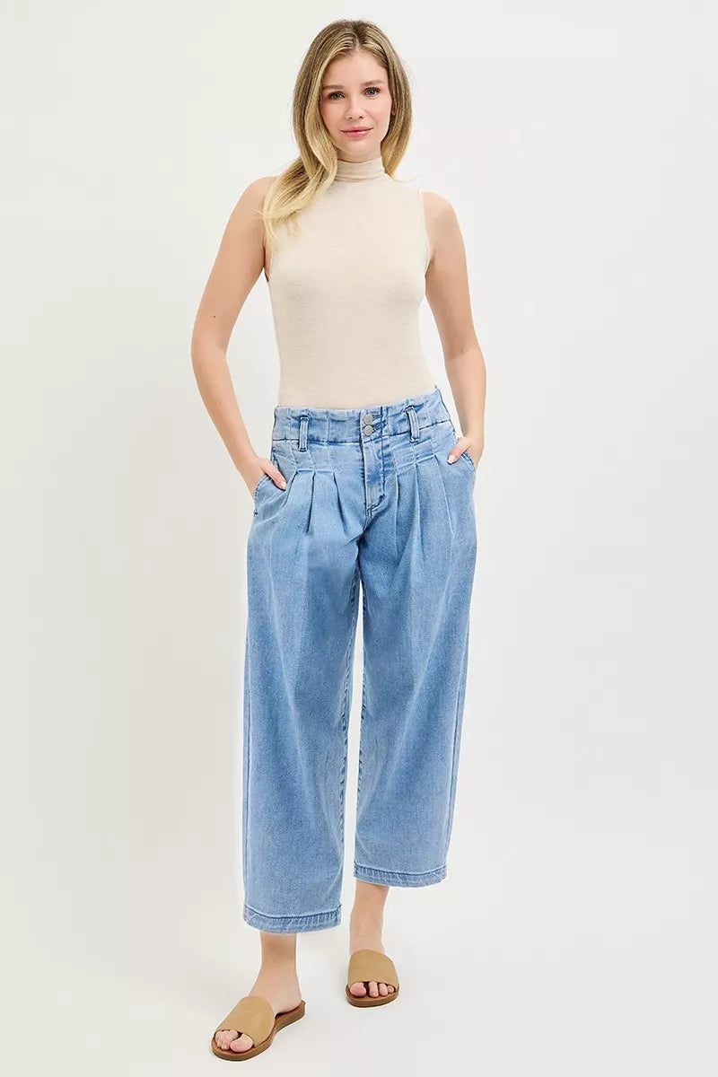 RISEN medium-blue slouchy crop barrel jeans on model, pleated waist and button fly
