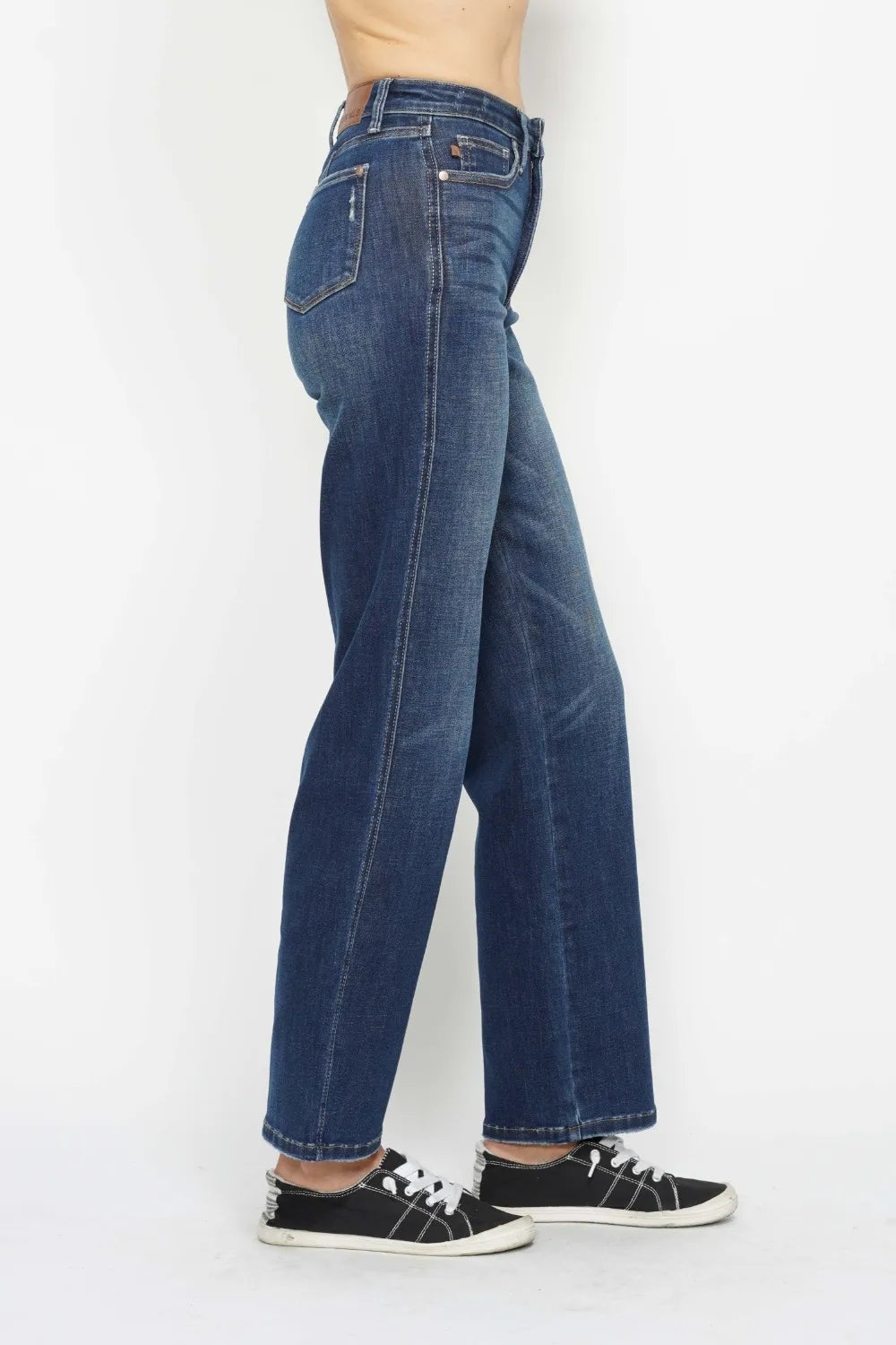 High-waist tummy control jeans, dark wash, angled back view with button waist closure.