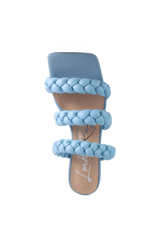 Light blue braided mule sandals with thick woven straps and covered heel