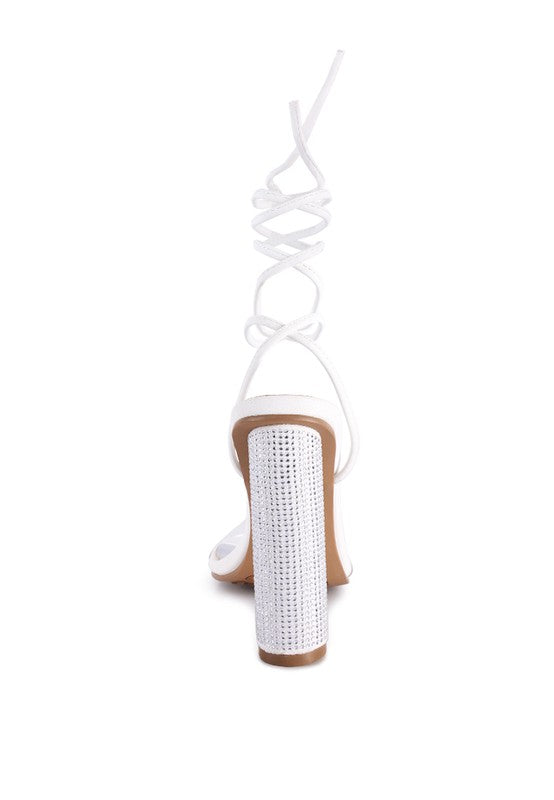 White lace-up high heel sandals showing back strap and tall jeweled heel