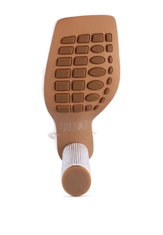Outsole of white lace-up high heel sandal with textured grip tread