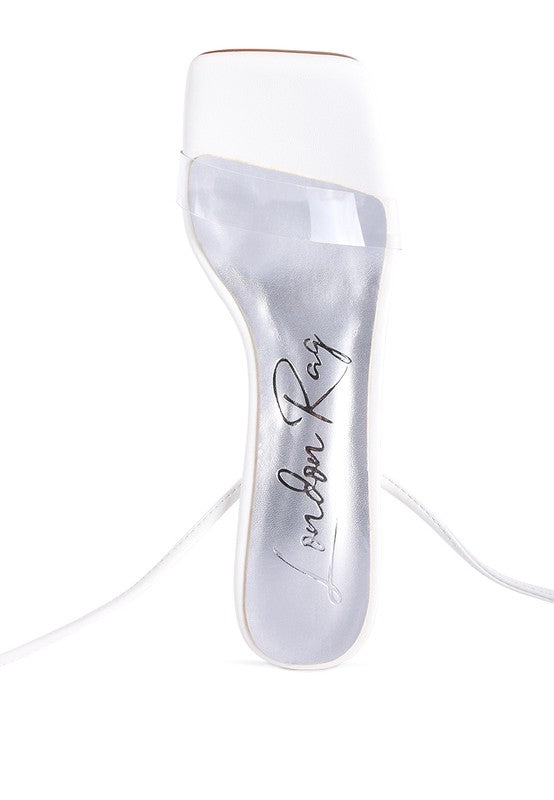 Clear view of white sandal insole with signature print and lace-up strap