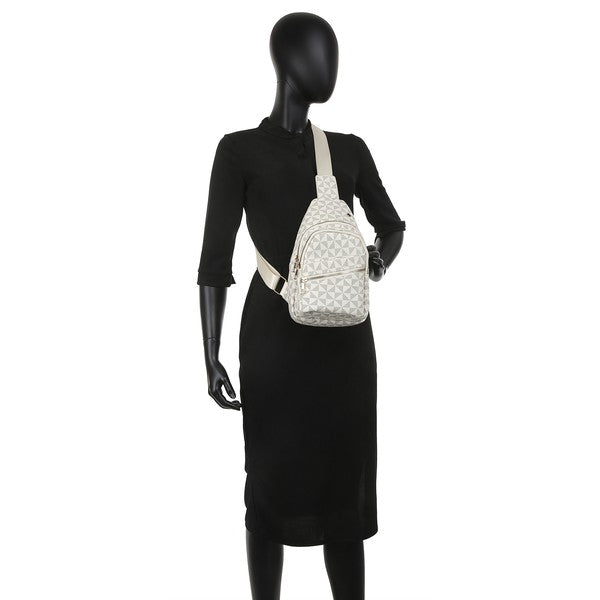 Black patterned sling backpack worn crossbody; front zip pocket with gold-tone hardware