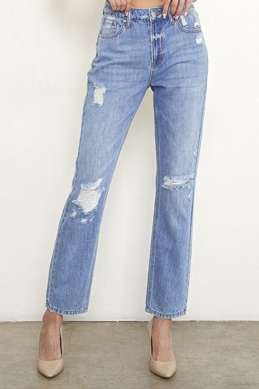 High-rise distressed girlfriend jeans, medium blue, large patchy tears at thighs and knees