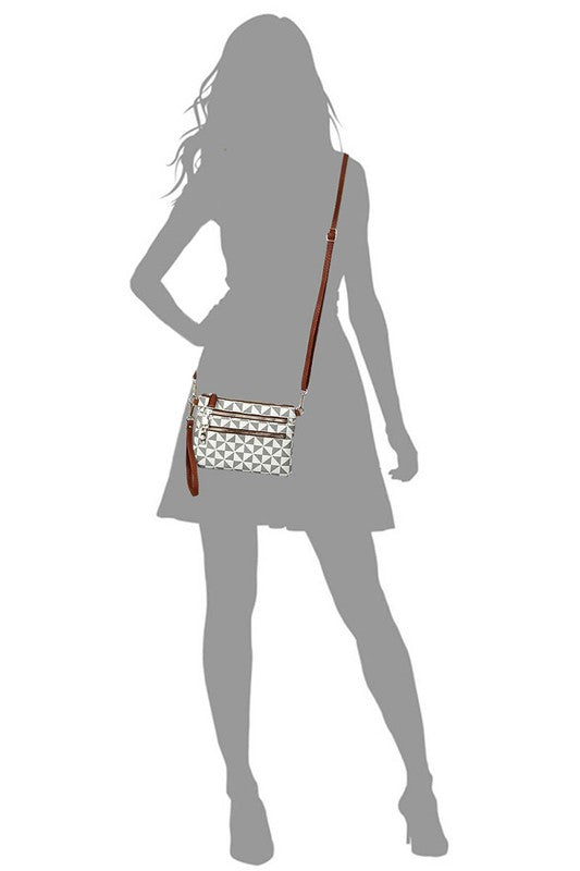 Crossbody clutch bag with black-and-white geometric print, worn over the shoulder
