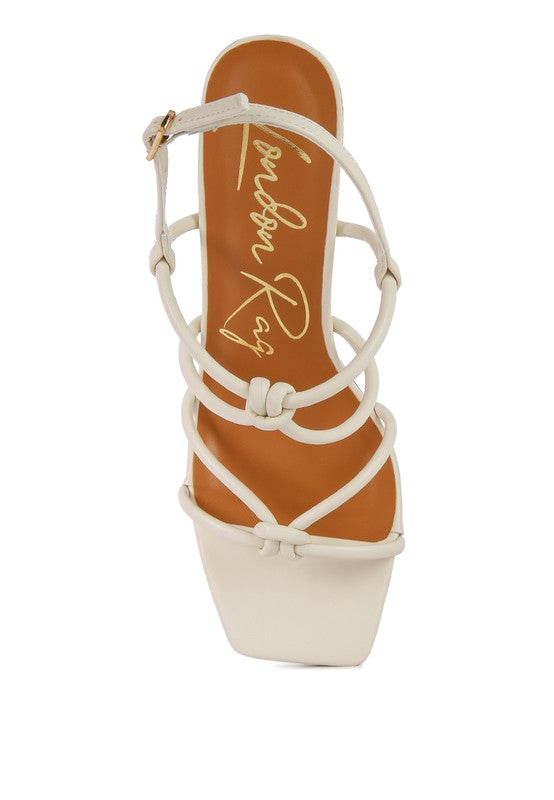 Cream sandal insole view with knotted straps and open toe
