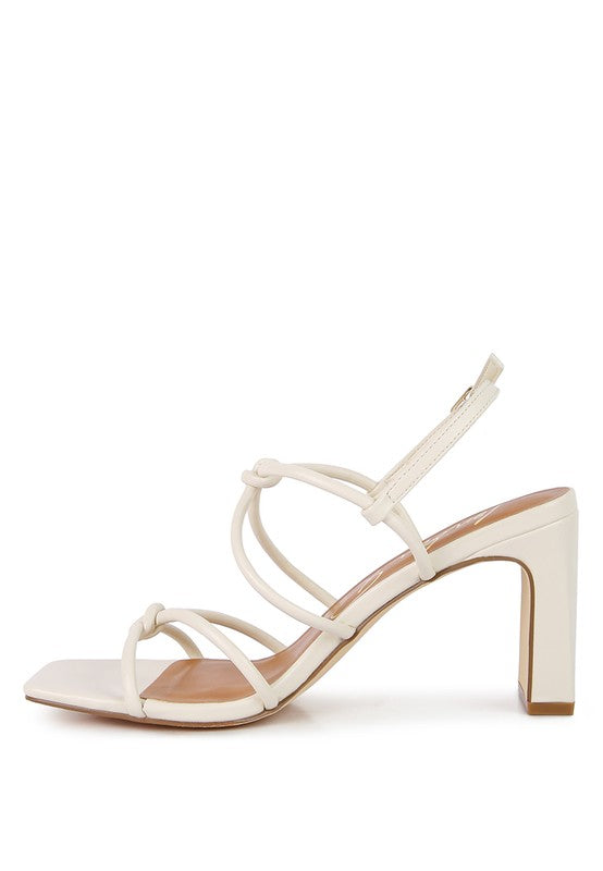 Cream high block-heel sandal with strappy crisscross design and knotted details