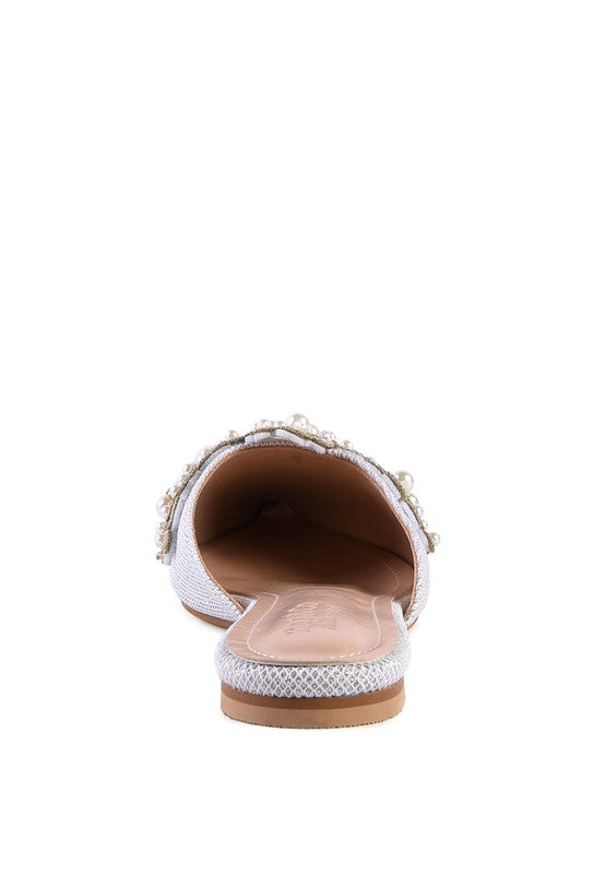 White pearl mules, interior view from back with flat sole