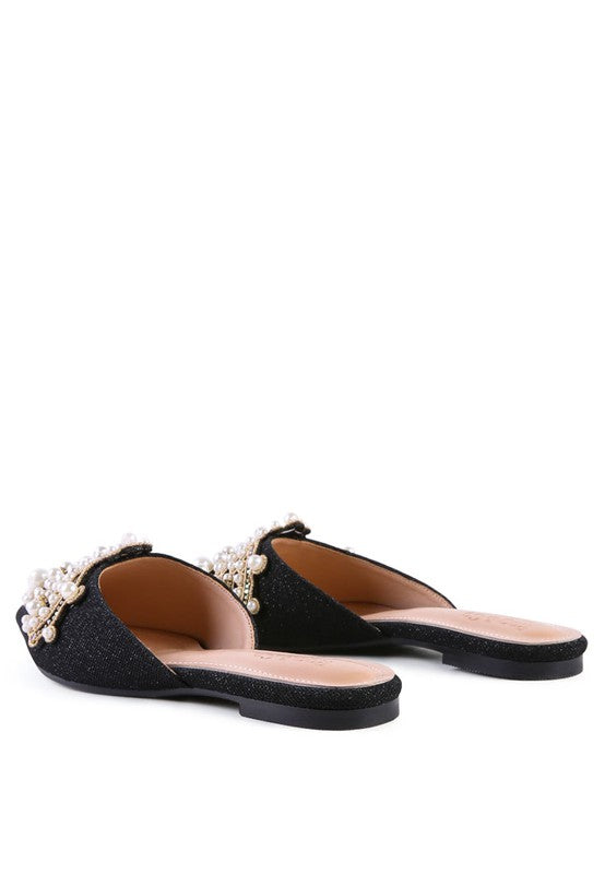Pair of black pearl mules with open slide toe and flat sole