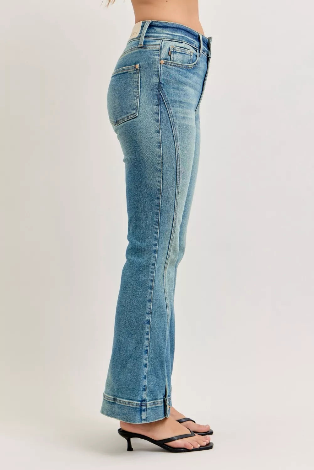 Side view of high-waist flare jeans in light blue vintage-wash denim