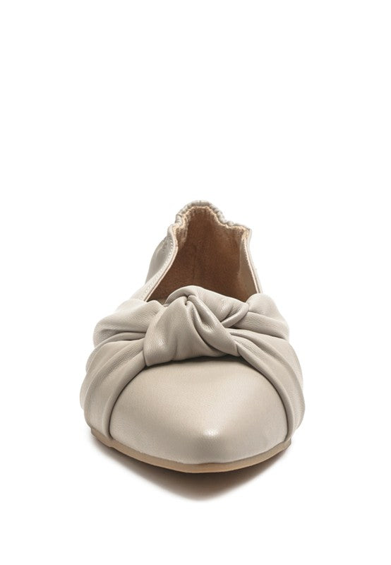 Cream ballet flats with knot detail at the toe and soft textured lining